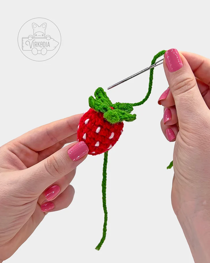 free crochet strawberry bookmark pattern tutorial demonstration of how to sew the leaves