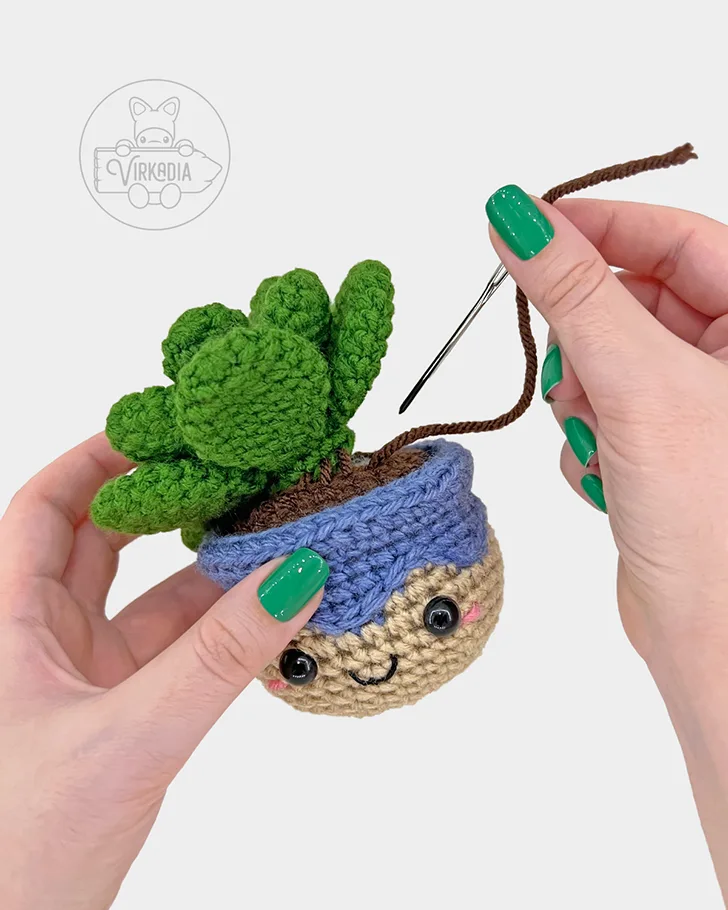 crochet succulent amigurumi pattern tutorial of how to sew the plant onto the pot