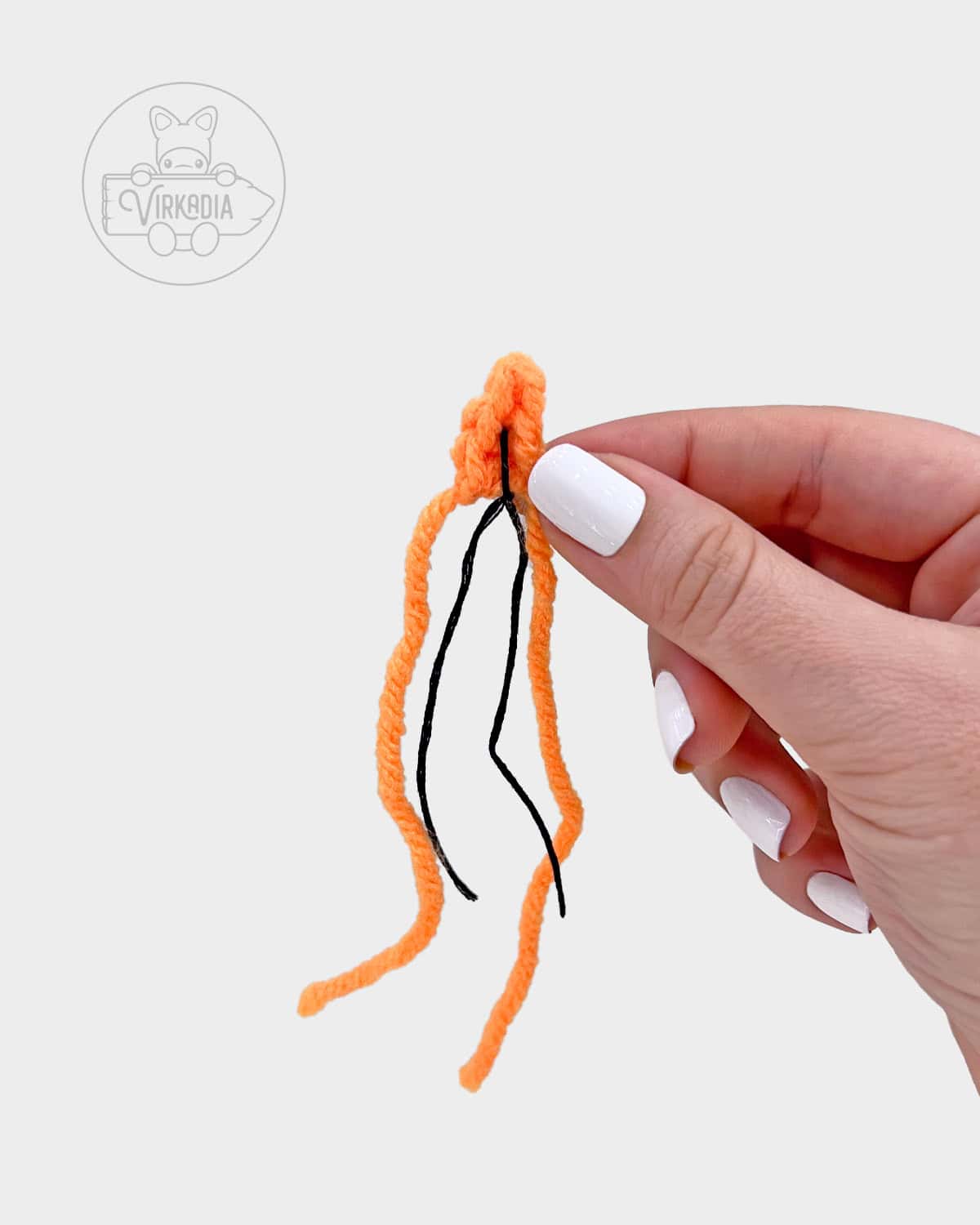 free amigurumi pattern tutorial of how to sew the wick onto the flame
