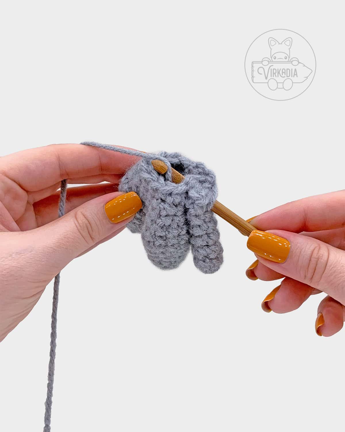 free amigurumi pattern tutorial of how to attach the arms to the body