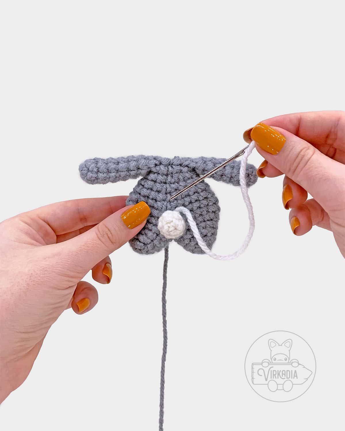 free crochet bunny amigurumi pattern tutorial of where to sew the tail onto the body