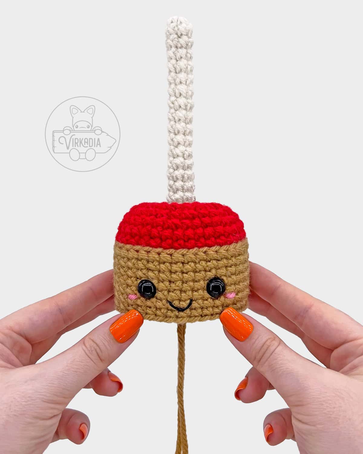 free crochet candy apple amigurumi tutorial of where the face should be embroidered