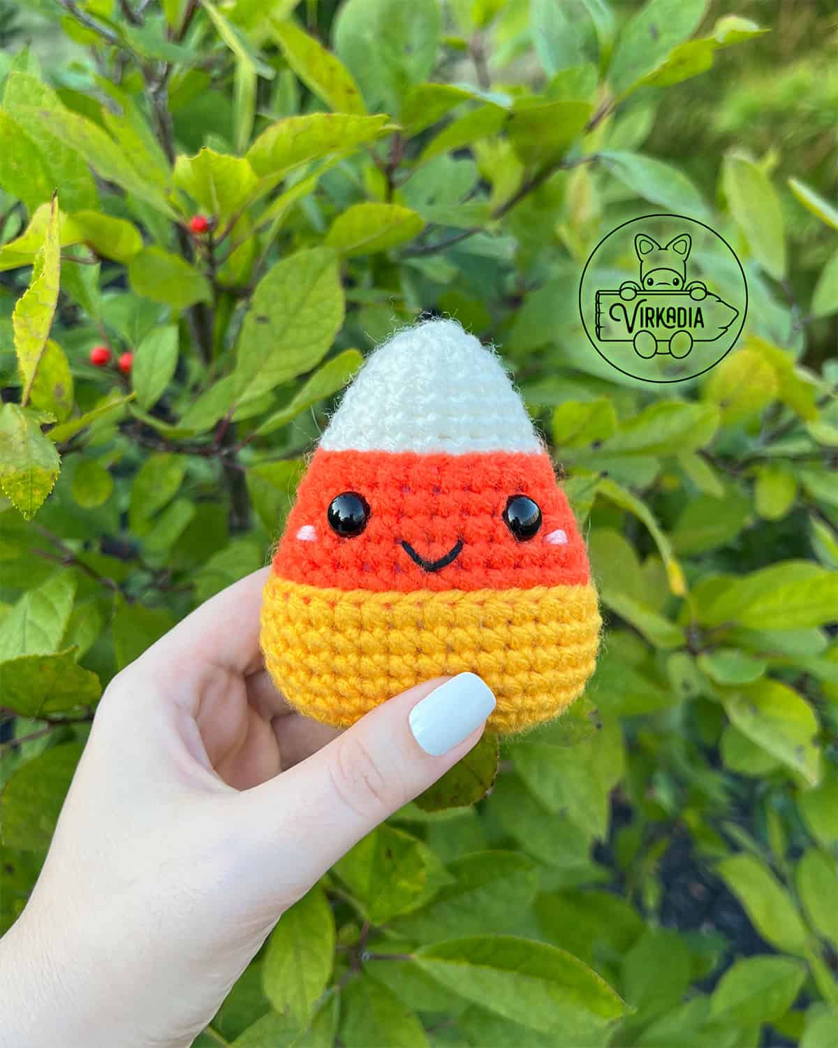 candid shot of free crochet candy corn amigurumi plushie for Halloween decorations, DIY fall decor, and handmade gifts