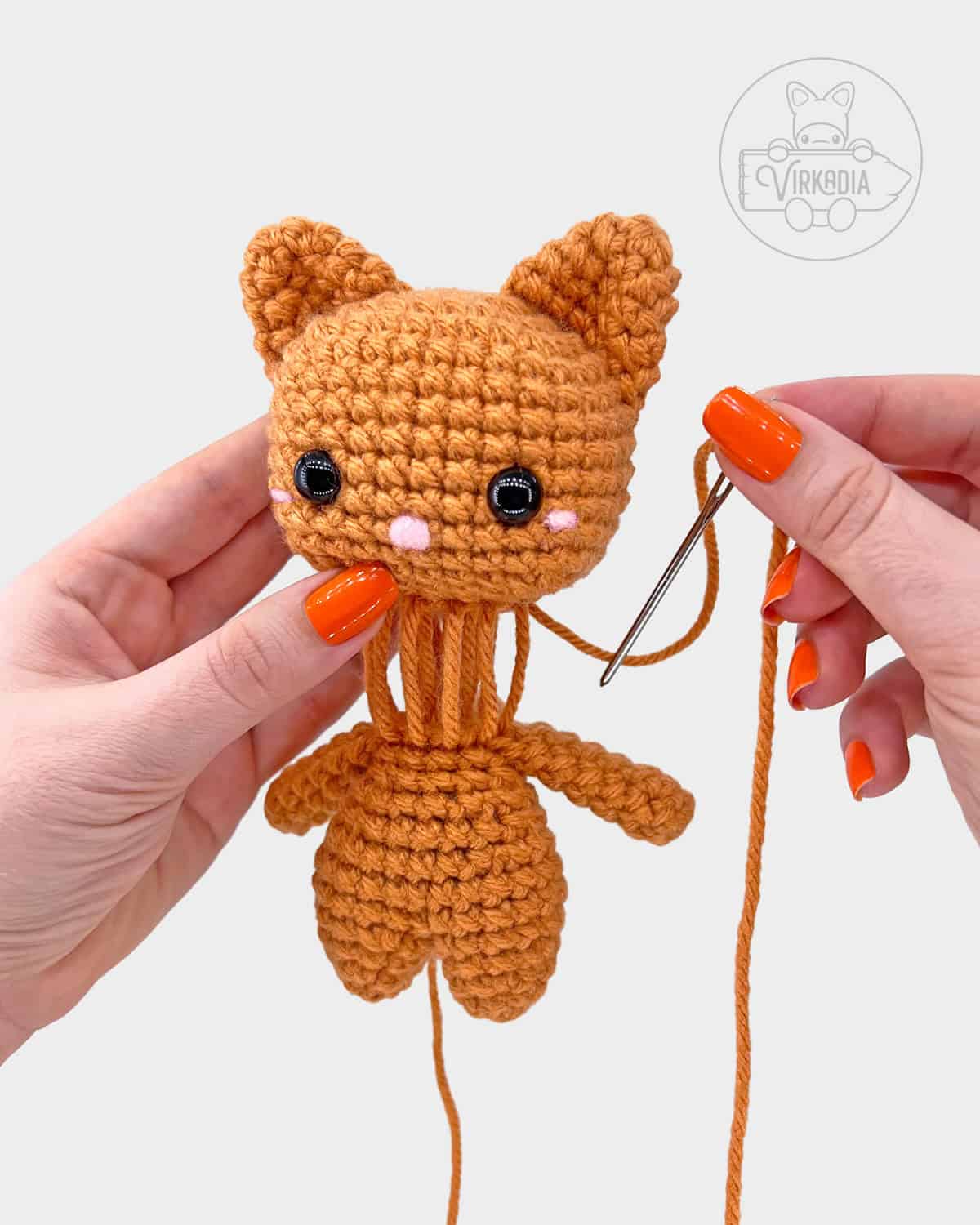 free crochet cat amigurumi pattern tutorial of how to attach the head