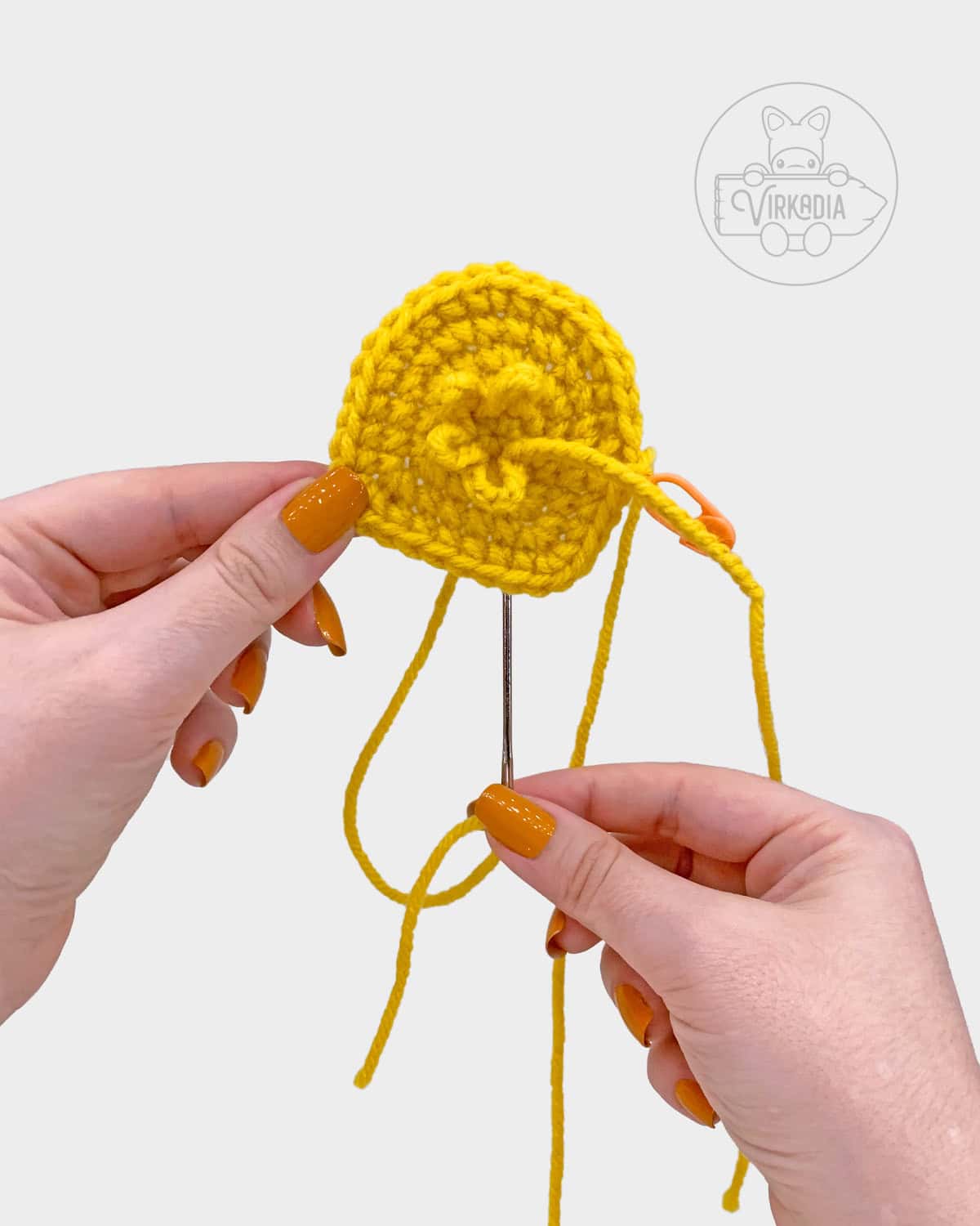 free amigurumi pattern tutorial of where the tuft should be sewn onto the head
