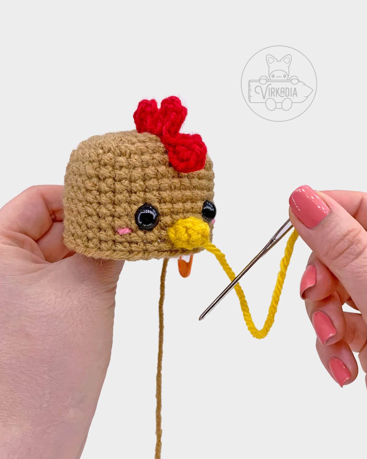free crochet chicken amigurumi pattern tutorial of how to sew the beak onto the head