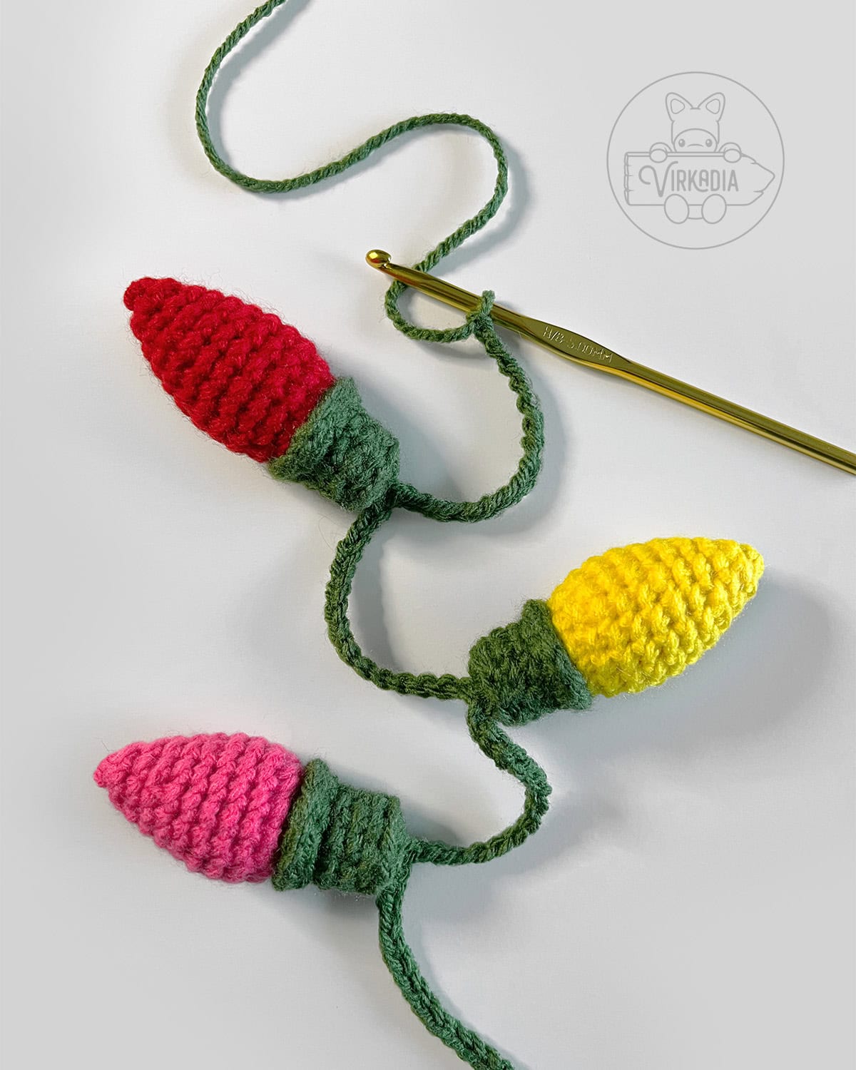 demonstration of how to attach bulbs onto crochet Christmas lights garland for winter decorations, DIY holiday decor, and handmade gifts