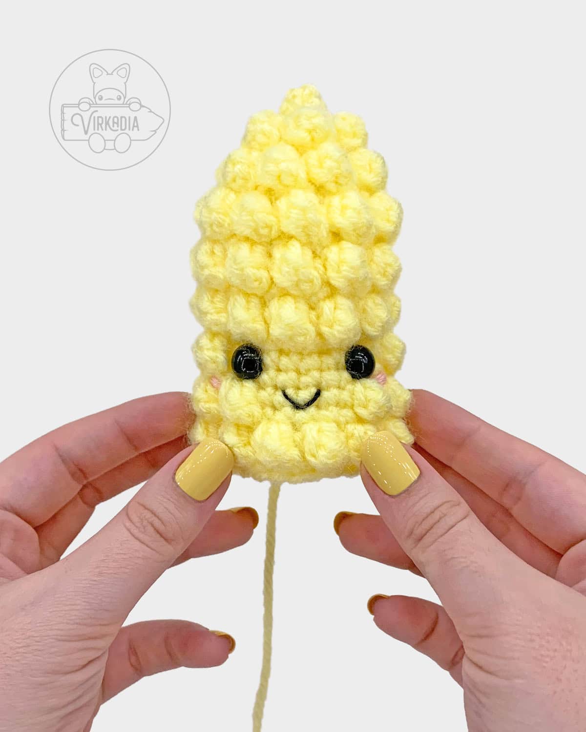free crochet corn amigurumi pattern tutorial of where to embroider the face on the cob