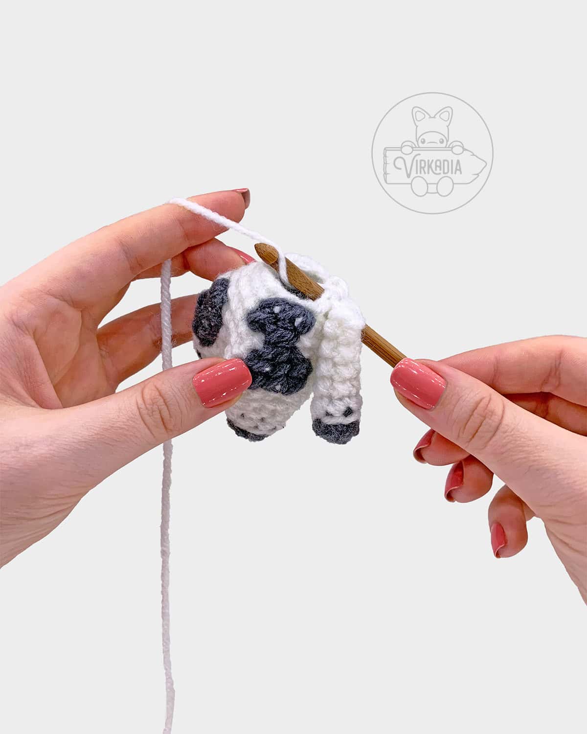 free amigurumi pattern tutorial of how to attach the arms to the body