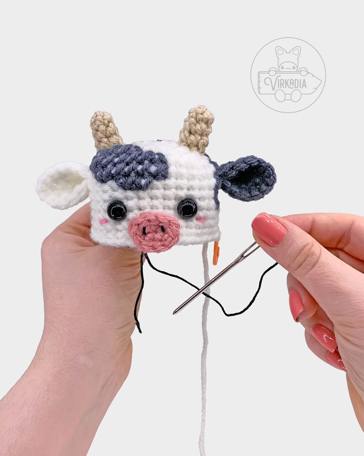 free crochet cow amigurumi pattern tutorial of how to sew the snout onto the head