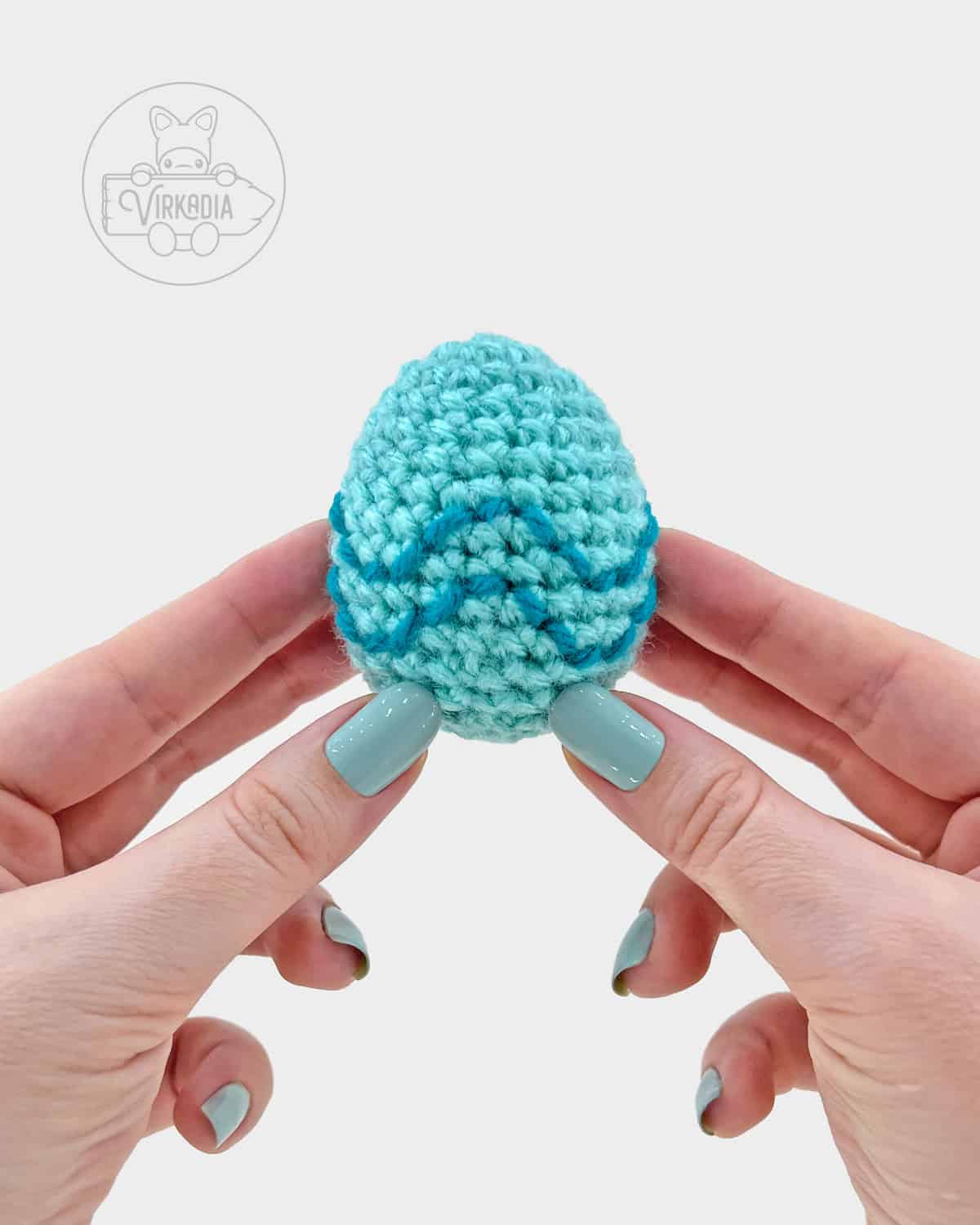 blue crochet easter egg amigurumi pattern, completed with embroidered wavy lines