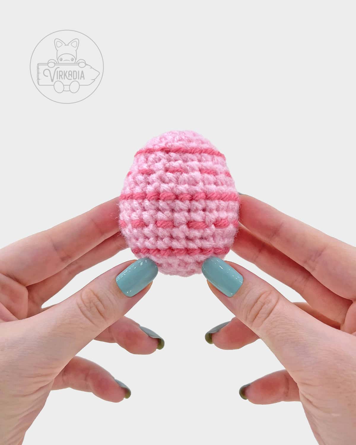 pink crochet easter egg amigurumi pattern, completed with embroidered stripes