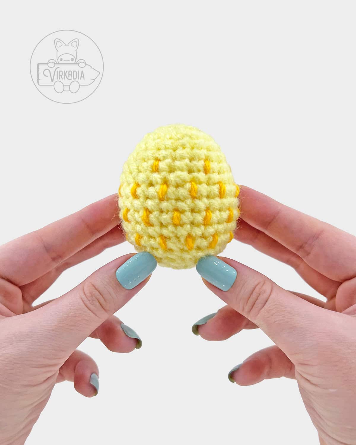 yellow crochet easter egg amigurumi pattern, completed with embroidered spots