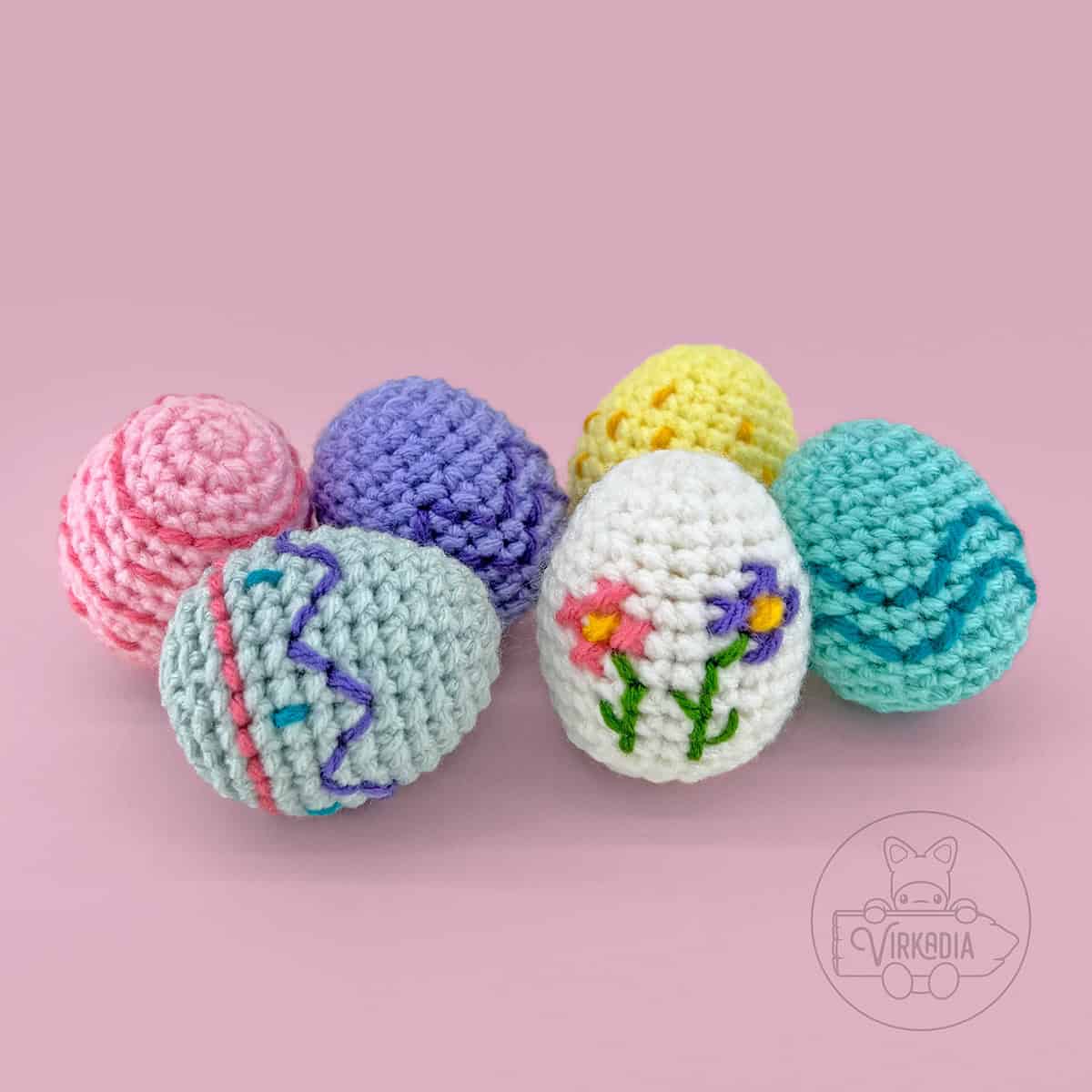 free crochet easter eggs pattern, including six different embroidered styles with stripes, spots, waves, zig-zags, and cross stitch flowers for DIY Easter home decor, DIY gifts for Easter baskets, and spring decorations