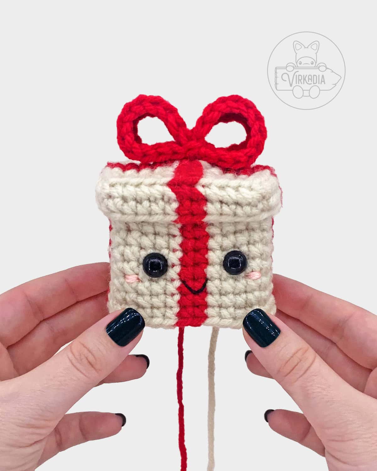 free crochet gift box amigurumi pattern tutorial of where to embroider the face onto the present
