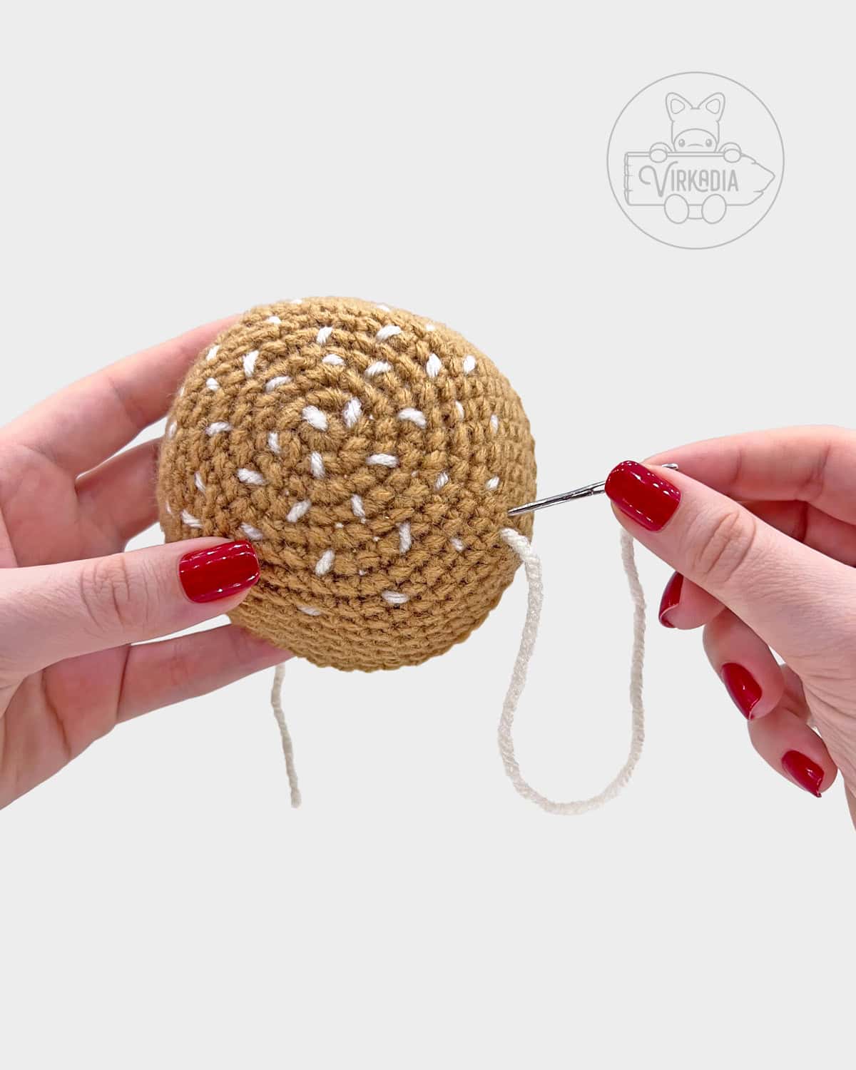 free crochet hamburger amigurumi pattern tutorial of how to embroider seeds onto the bun