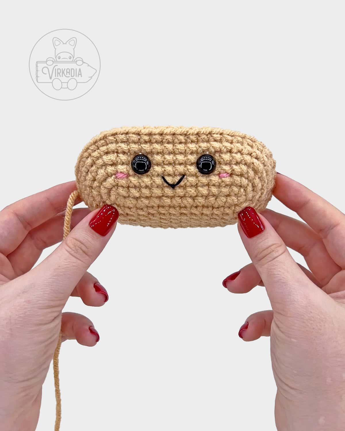 free crochet hot dog amigurumi pattern tutorial of where the face should be embroidered on the bun