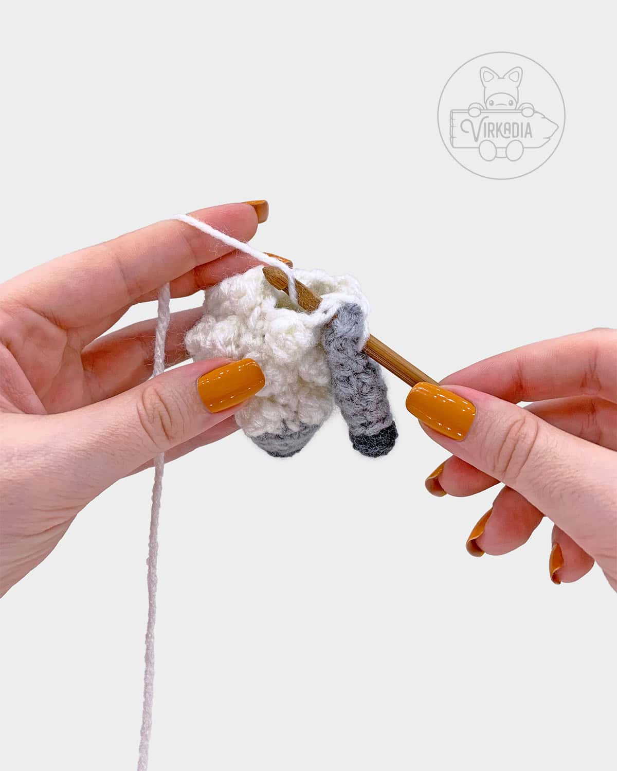 free amigurumi pattern tutorial of how to attach the arms to the body