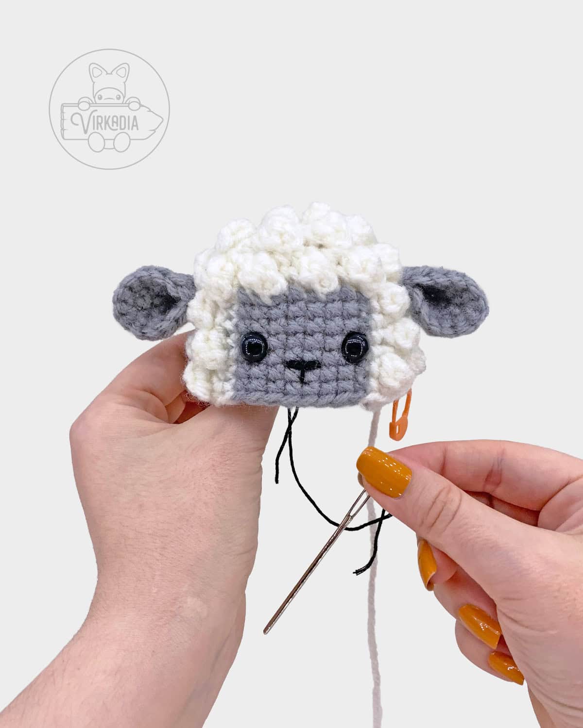 free crochet lamb amigurumi pattern tutorial of how to embroider the nose onto the face