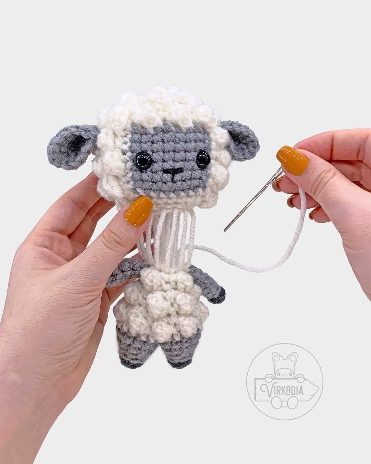 free crochet lamb amigurumi pattern tutorial of how to sew the head onto the body
