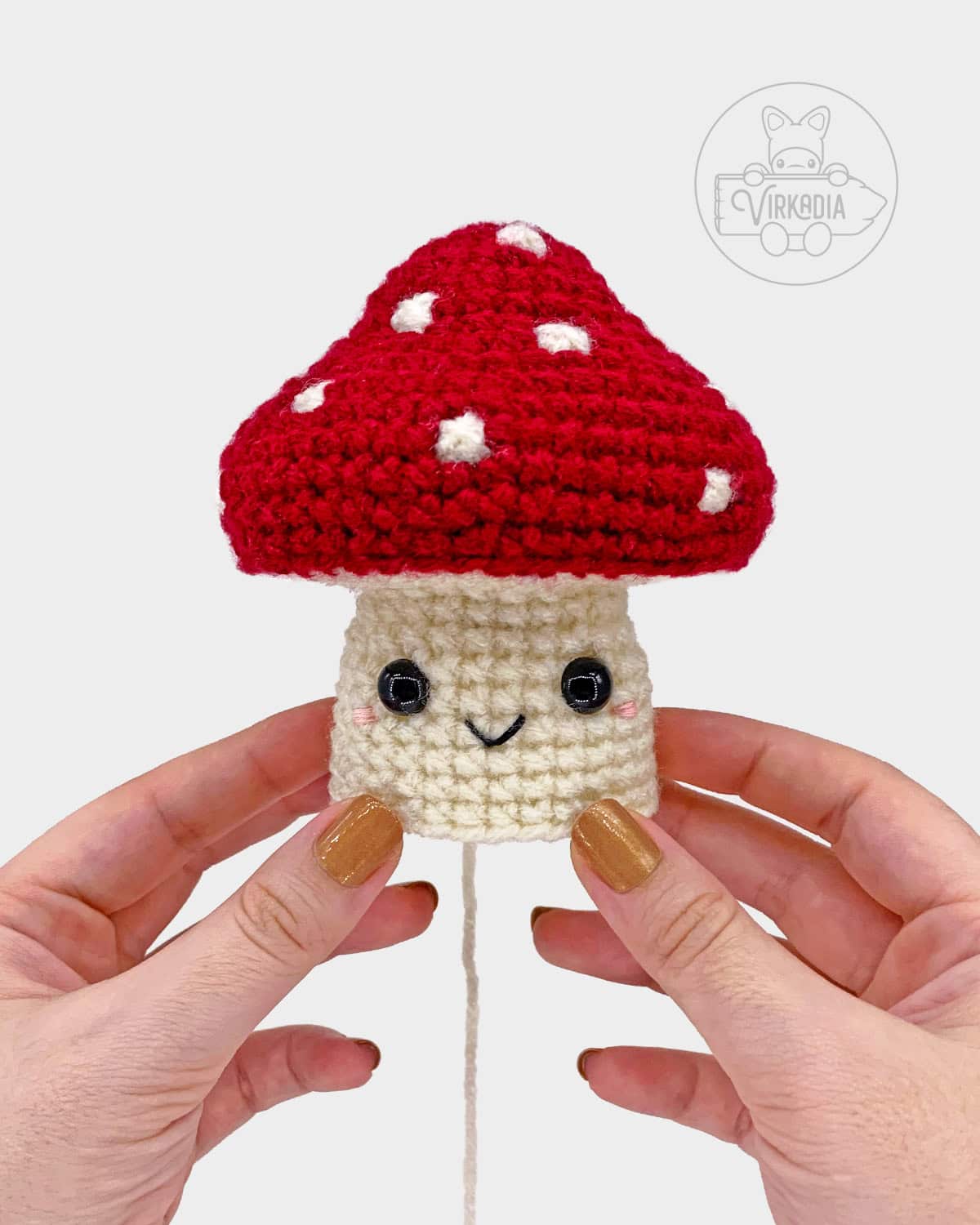 free crochet mushroom amigurumi pattern tutorial of where to embroider the face on the stalk
