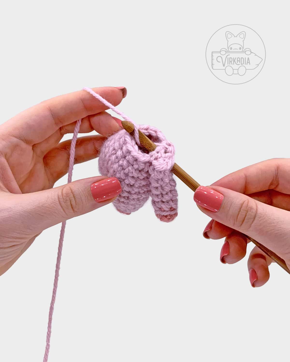free amigurumi pattern tutorial of how to attach the arms to the body