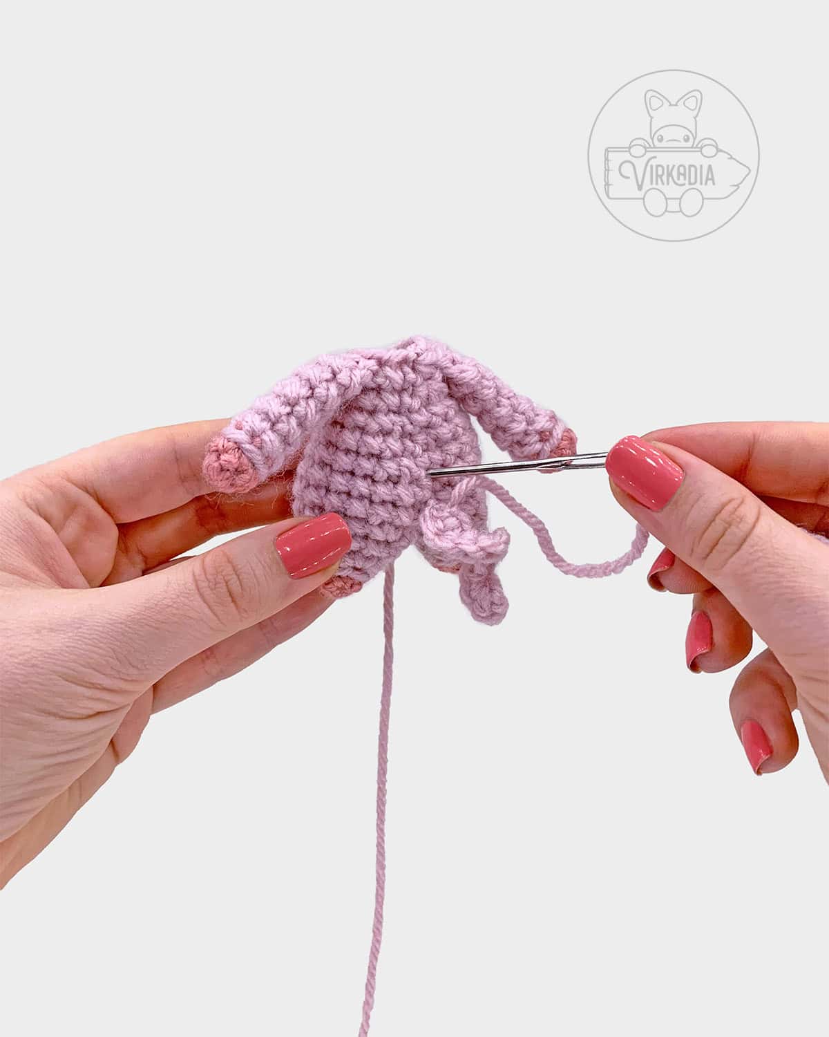 free crochet pig amigurumi pattern tutorial of how to sew the tail onto the body