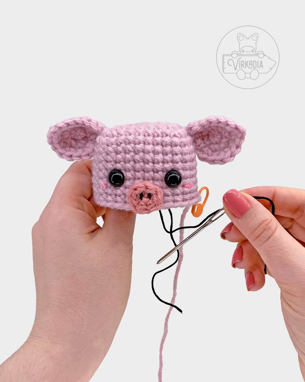 free crochet pig amigurumi pattern tutorial of how to sew the snout onto the head