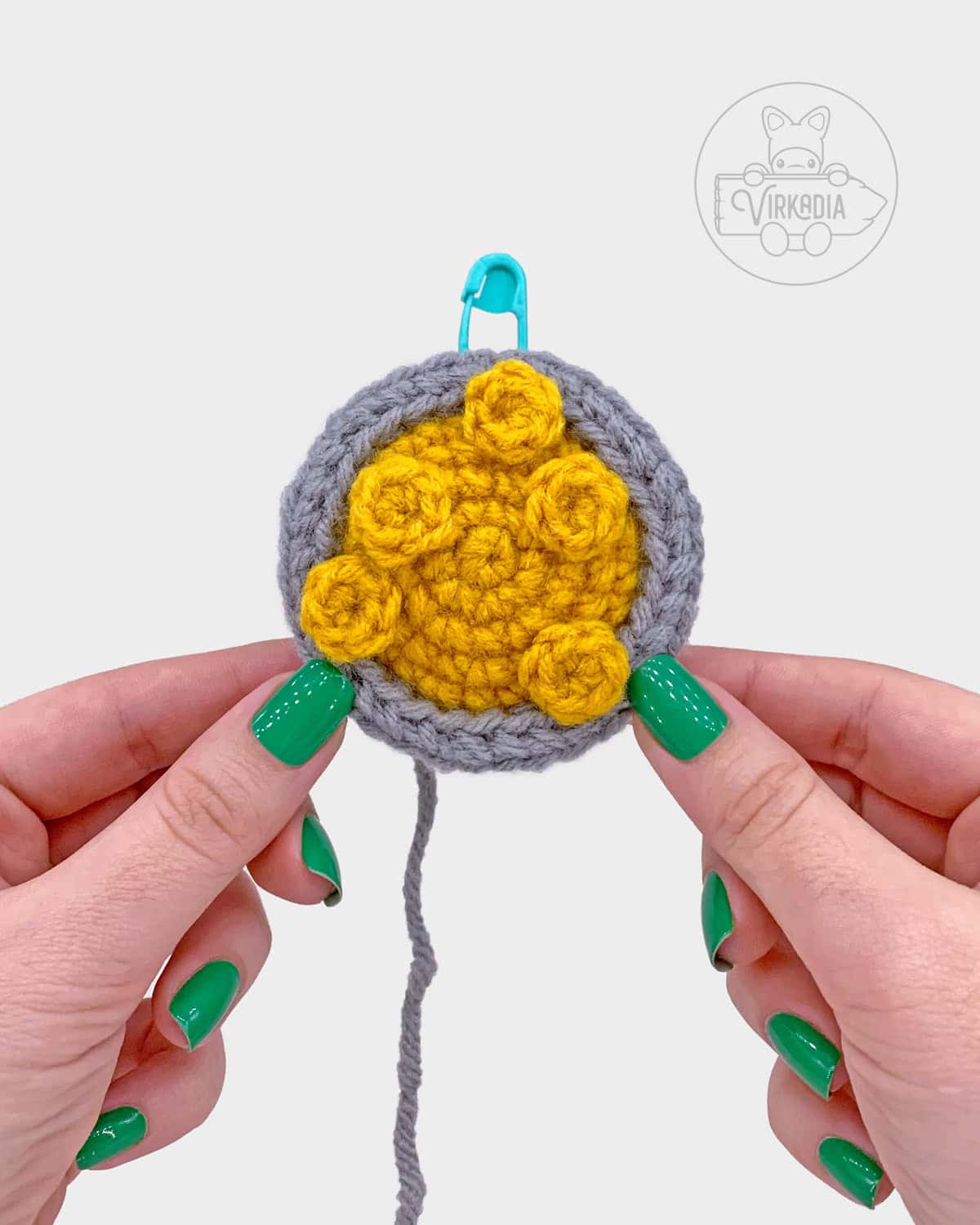 free crochet pot of gold amigurumi pattern tutorial of how the coins sewn on should look