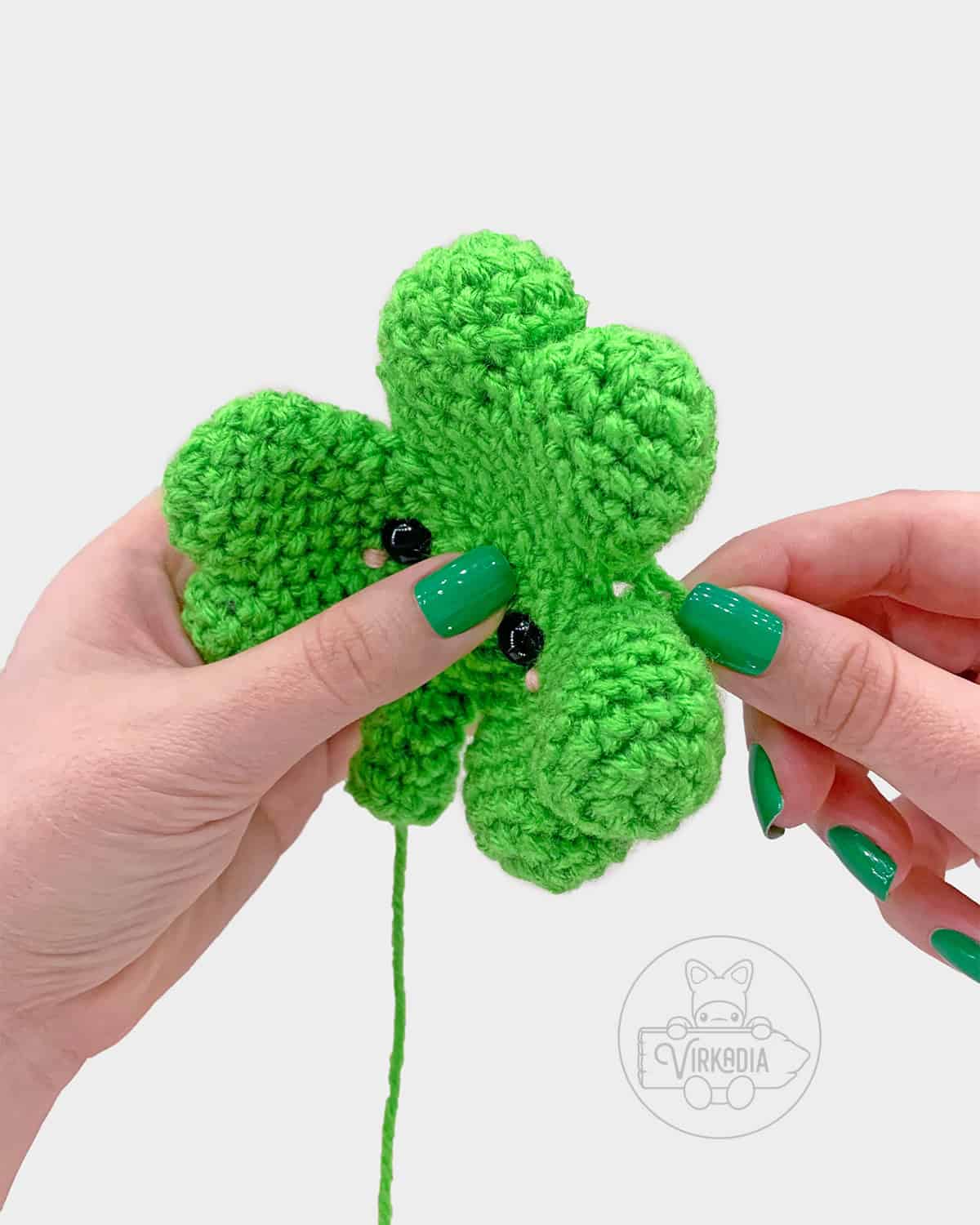 free crochet shamrock amigurumi pattern tutorial of where the holes should be tied closed