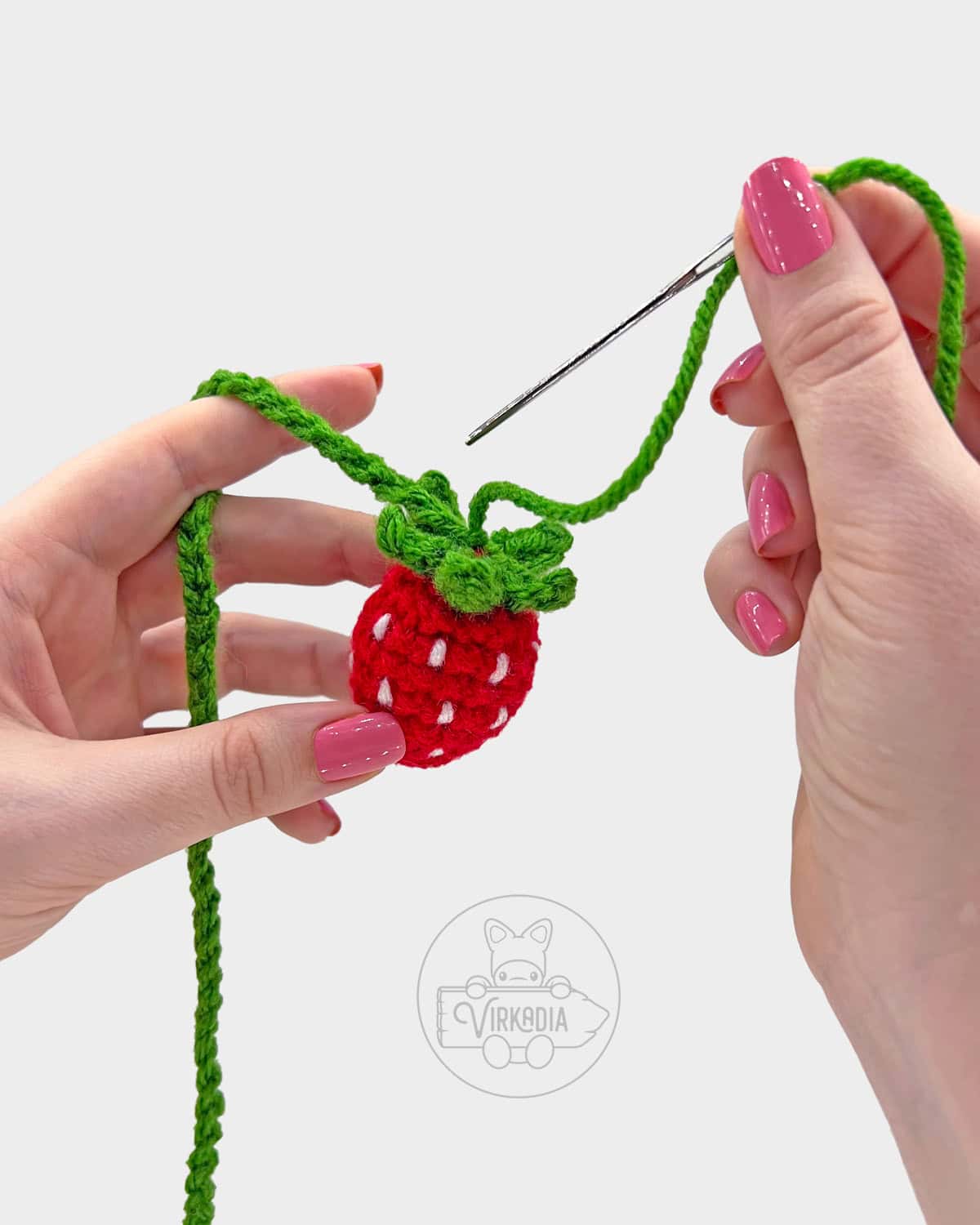 free crochet strawberry bookmark pattern tutorial of how to sew the string to the fruit