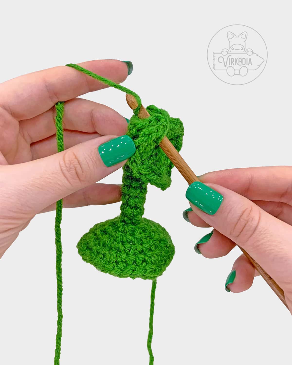 free crochet sunflower amigurumi pattern tutorial demonstration of how to attach the large leaves