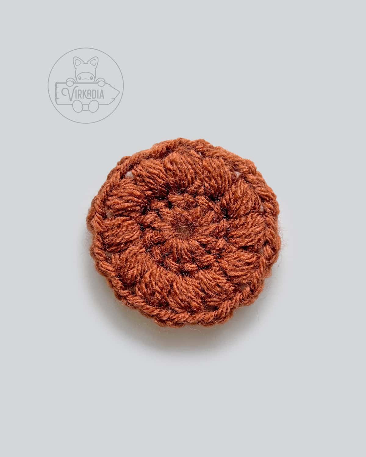 free crochet sunflower motif pattern tutorial of how round 2 should look after working the puff stitches