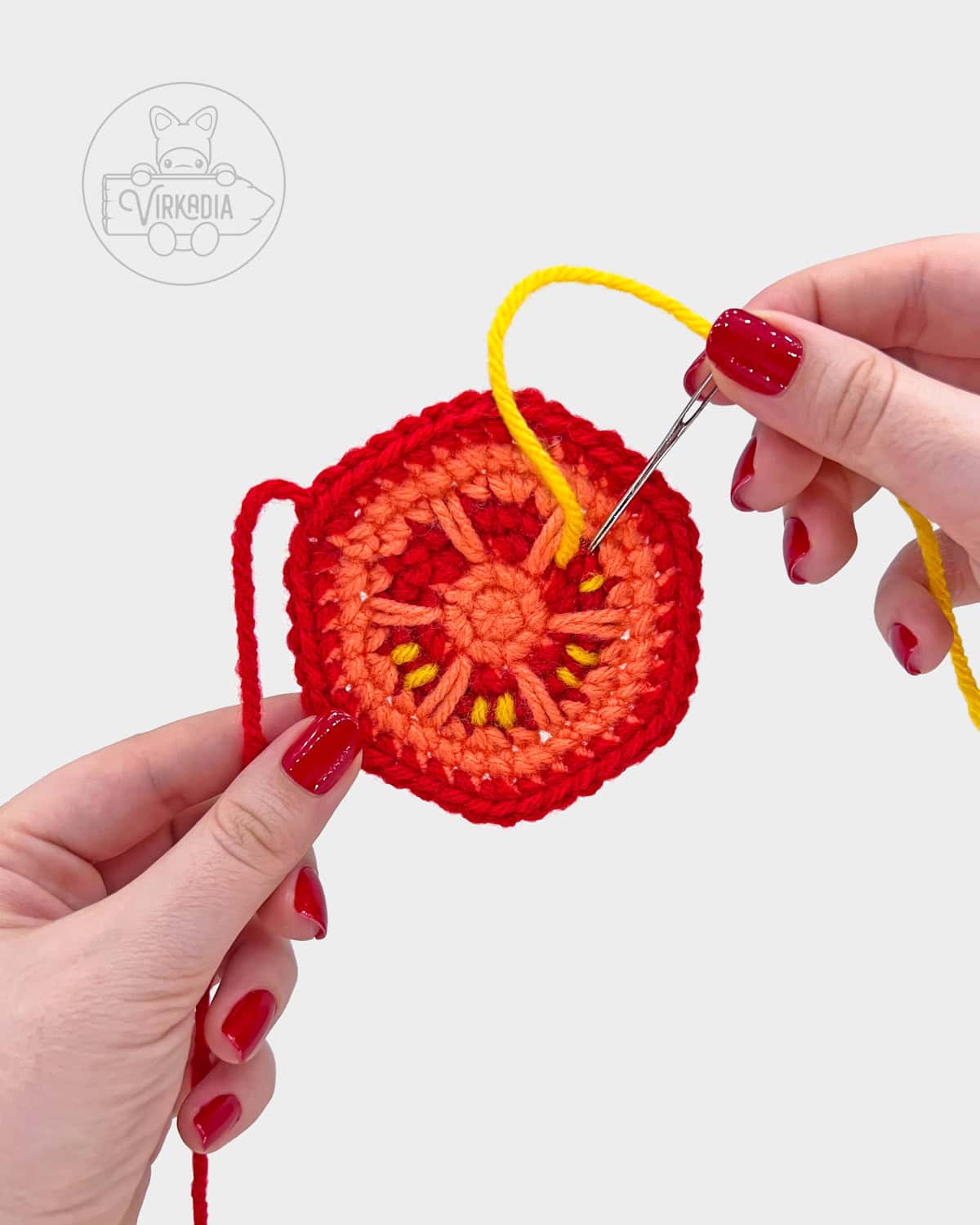 free crochet hamburger amigurumi pattern tutorial of how to embroider the seeds onto the tomato slice