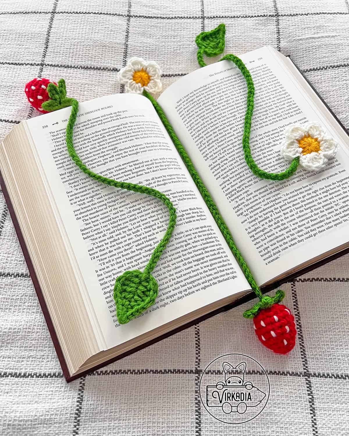 free crochet strawberry bookmark set in a book for spring crafts, summer reading, cottagecore decorations, and DIY gifts