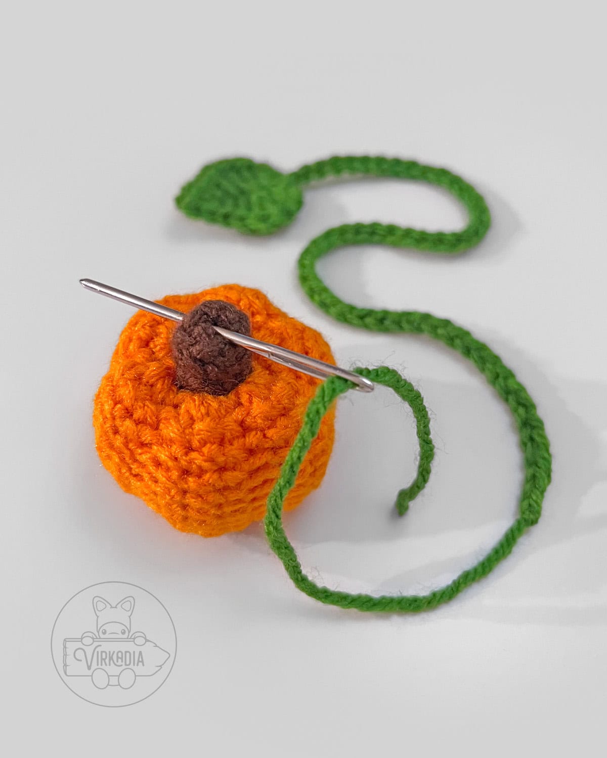how to sew the leaf string into the top of your mini crochet pumpkin bookmark