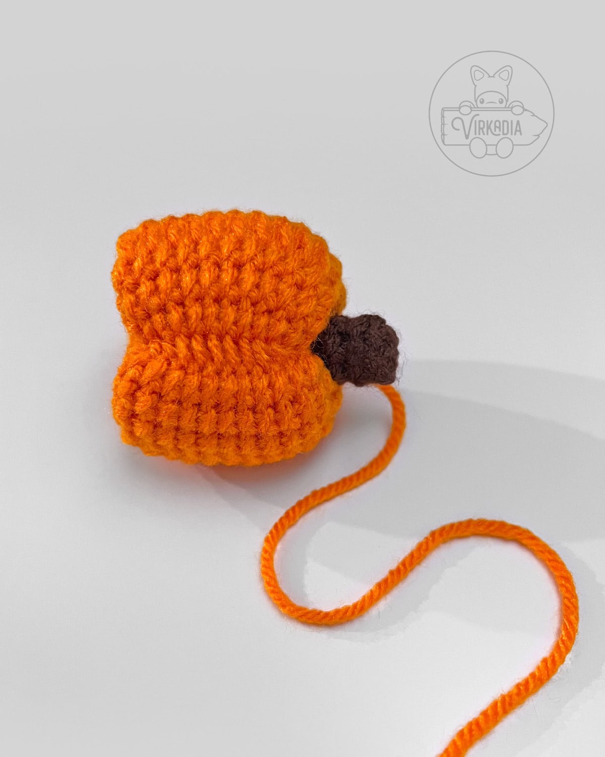 what the side of the mini crochet pumpkin amigurumi should look like after cinching
