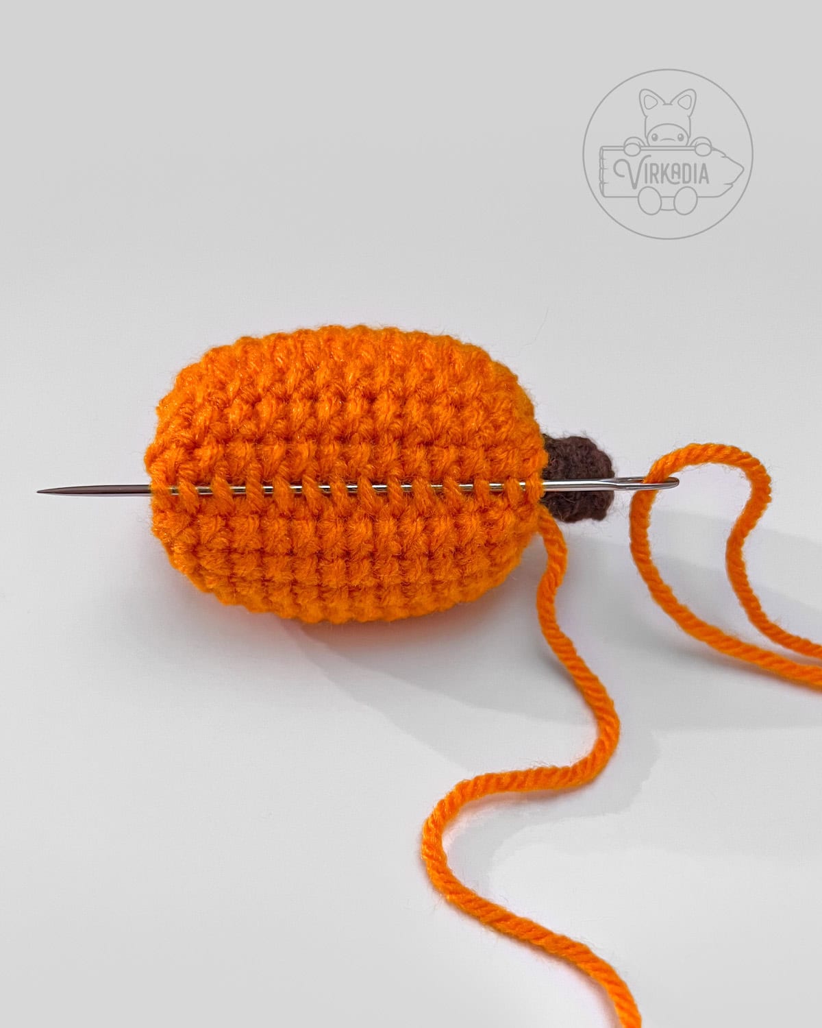 how to cinch the sides of the mini crochet pumpkin amigurumi for bookmarks and garlands
