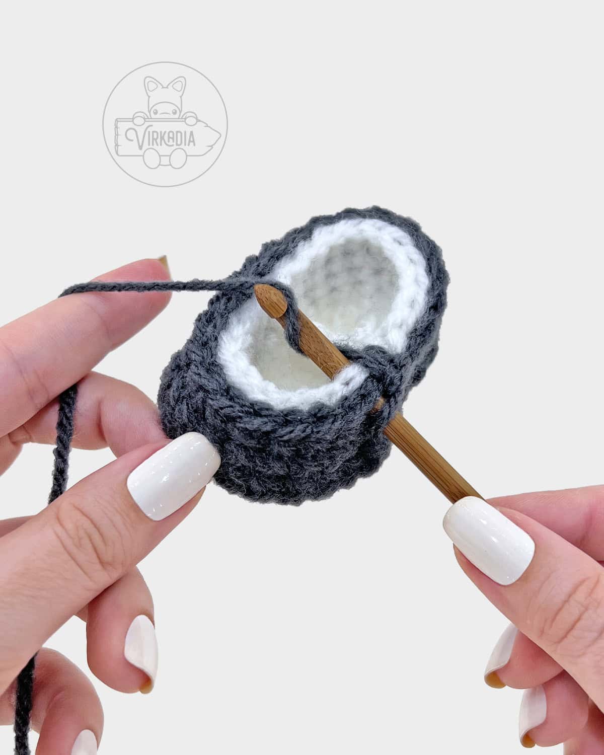 free amigurumi pattern tutorial of how to attach the bottom of the robe onto the legs