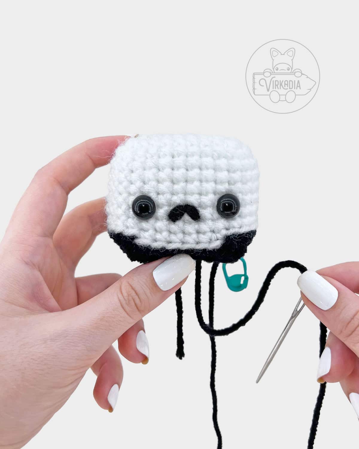 crochet grim reaper amigurumi pattern tutorial of how to embroider the nose onto the skull face
