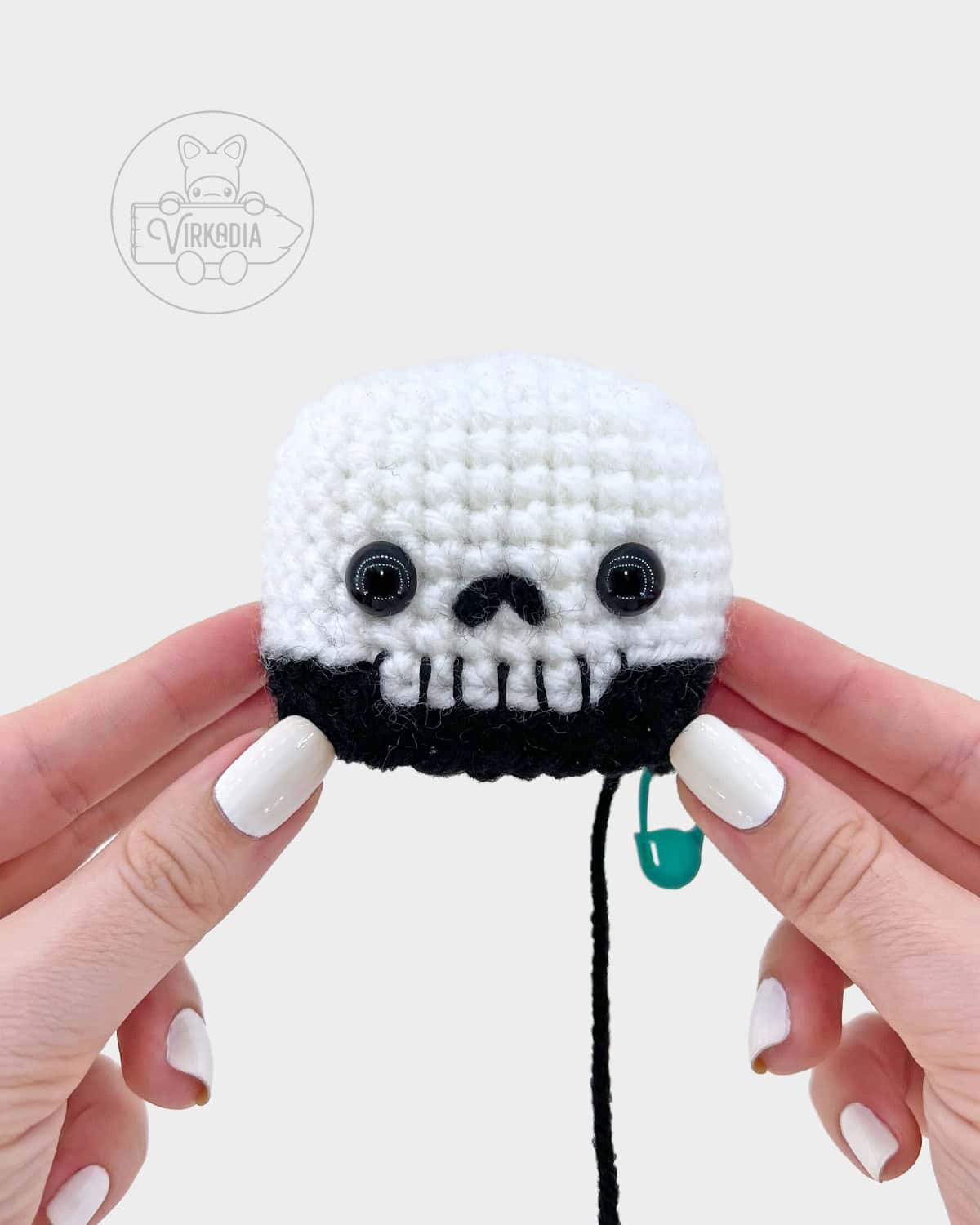 crochet grim reaper amigurumi pattern tutorial of how the finished skull face should look after embroidering