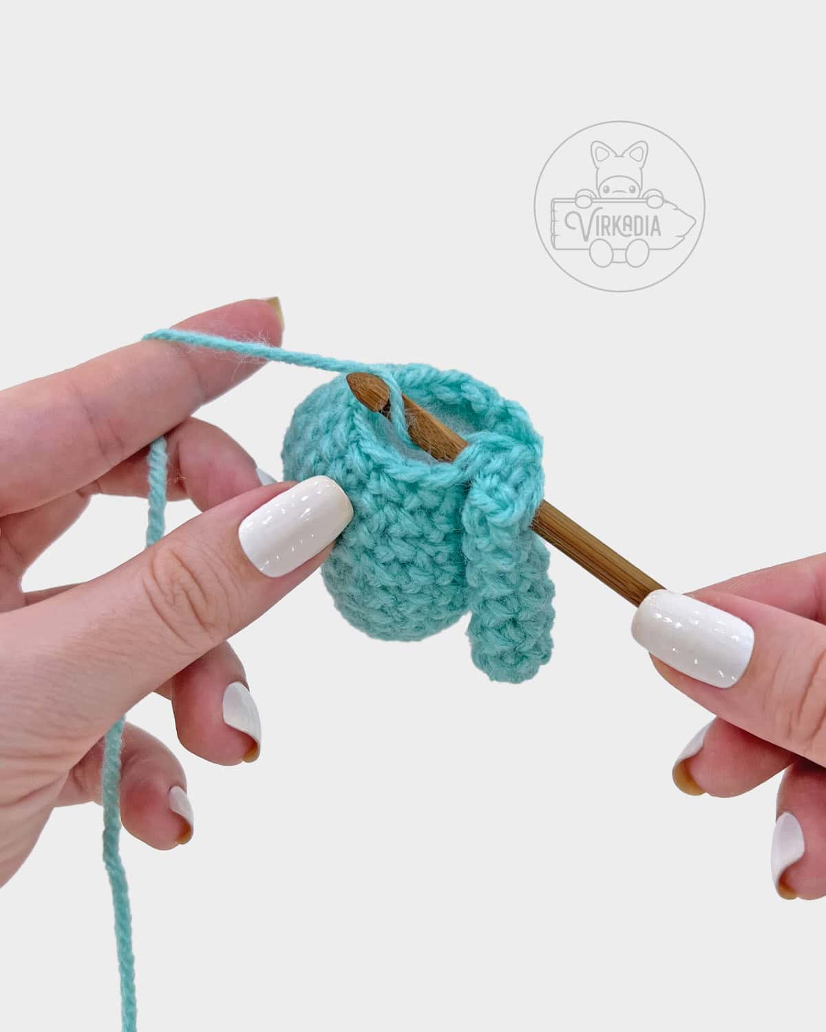 free amigurumi pattern tutorial of how to attach the arm onto the body