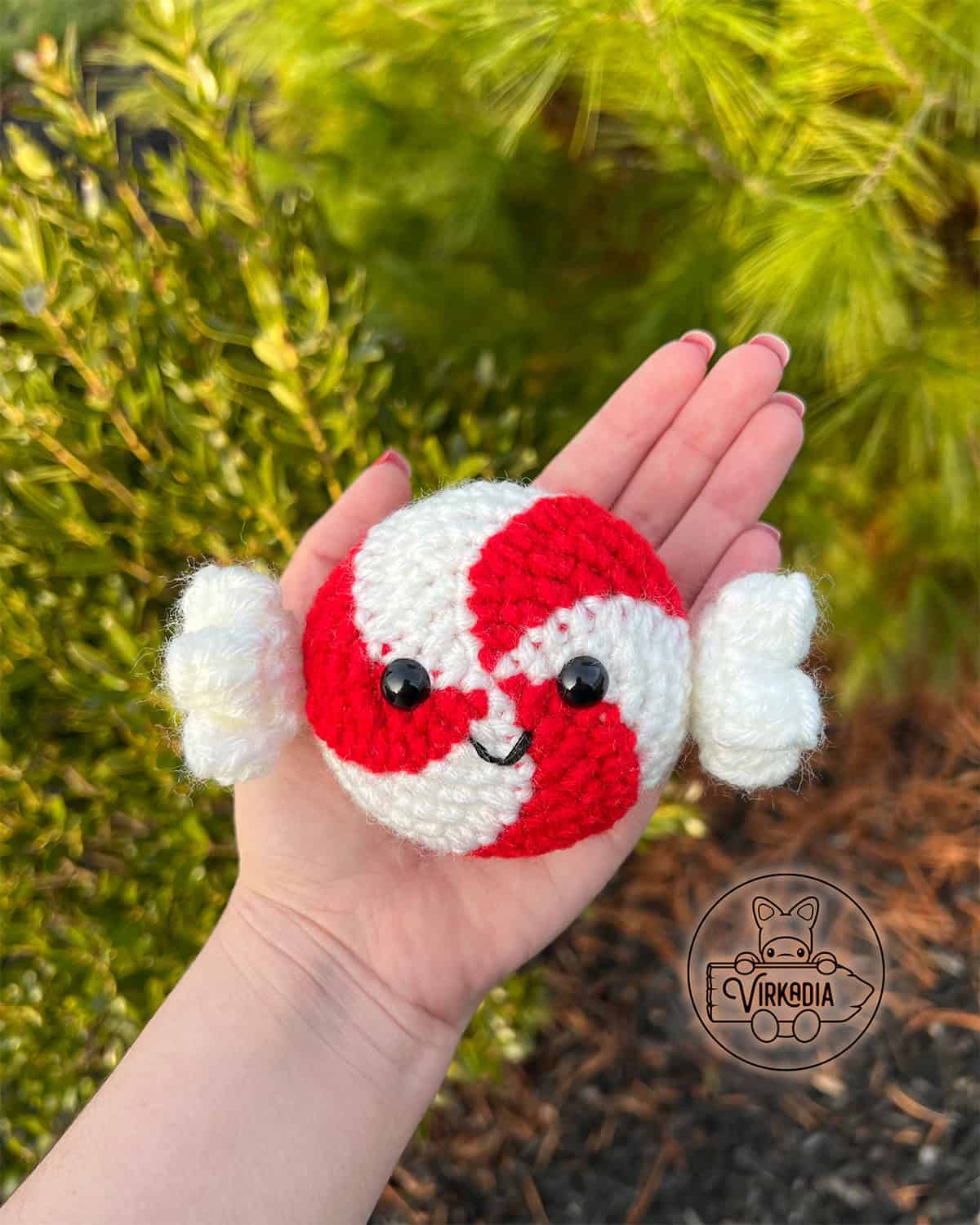 candid shot of crochet peppermint candy amigurumi plushie for Christmas decorations, DIY winter decor, and handmade holiday gifts