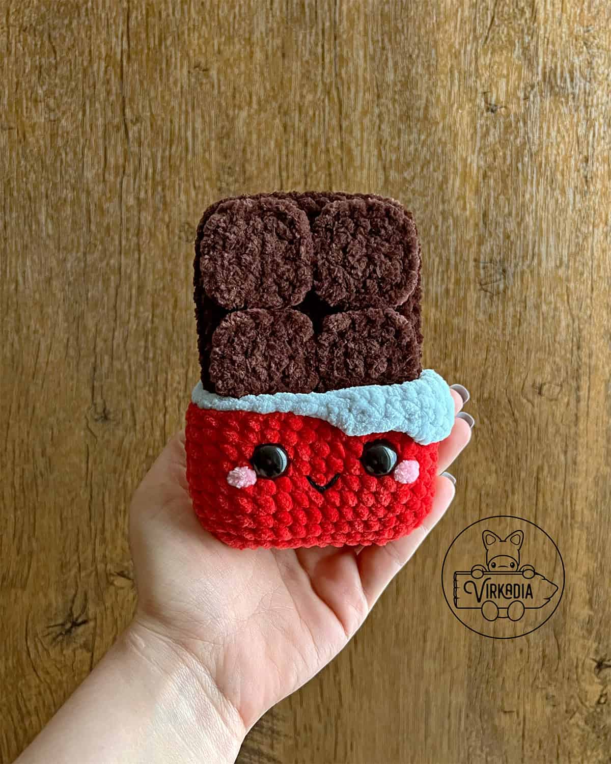candid shot of crochet chocolate bar amigurumi plushie in chunky yarn for Valentine's Day decorations, DIY holiday decor, and handmade romantic gifts