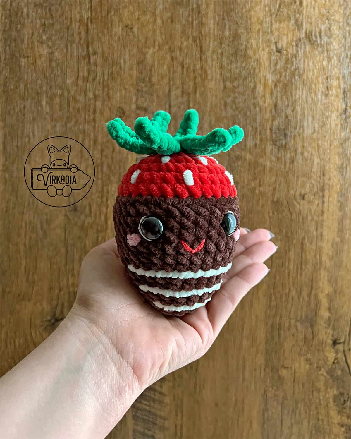 candid shot of crochet chocolate strawberry amigurumi plushie in chunky yarn for Valentine's Day decorations, DIY holiday decor, and handmade romantic gifts