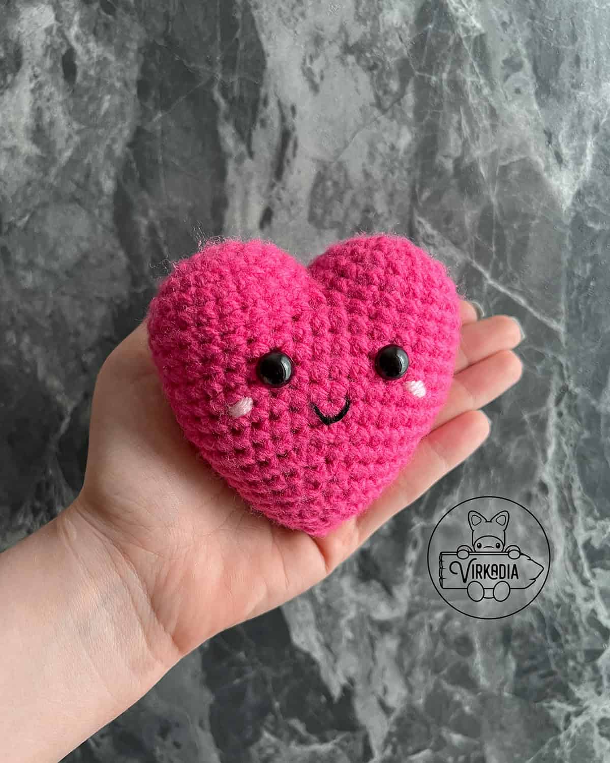 candid shot of crochet heart amigurumi plushie for Valentine's Day decorations, DIY holiday decor, and handmade romantic gifts
