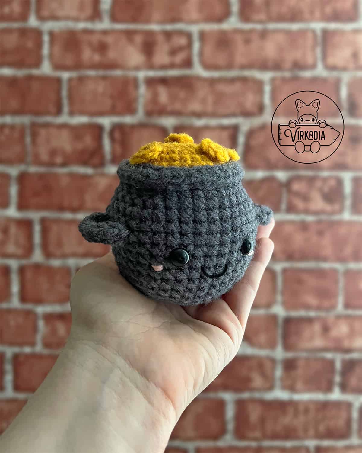 candid shot of crochet pot of gold amigurumi plushie for St. Patrick's Day decorations, spring crafts, DIY holiday decor, and handmade gifts