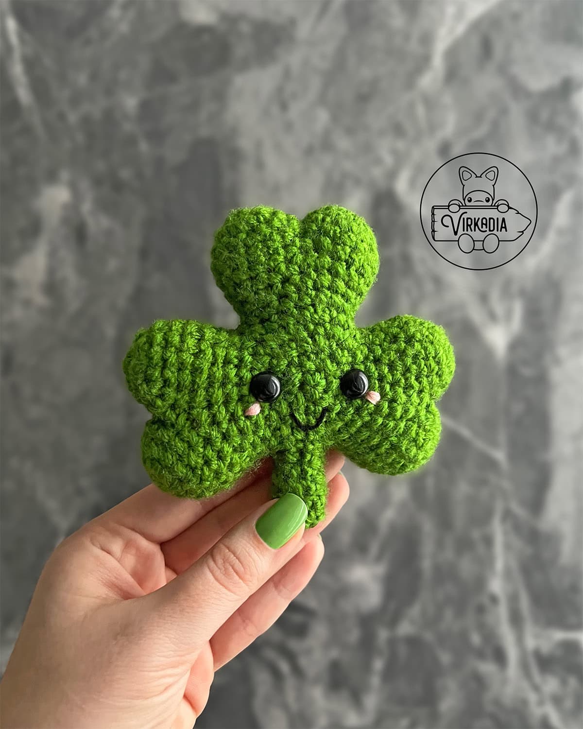 candid shot of crochet shamrock amigurumi plushie for St. Patrick's Day decorations, spring crafts, DIY holiday decor, and handmade gifts