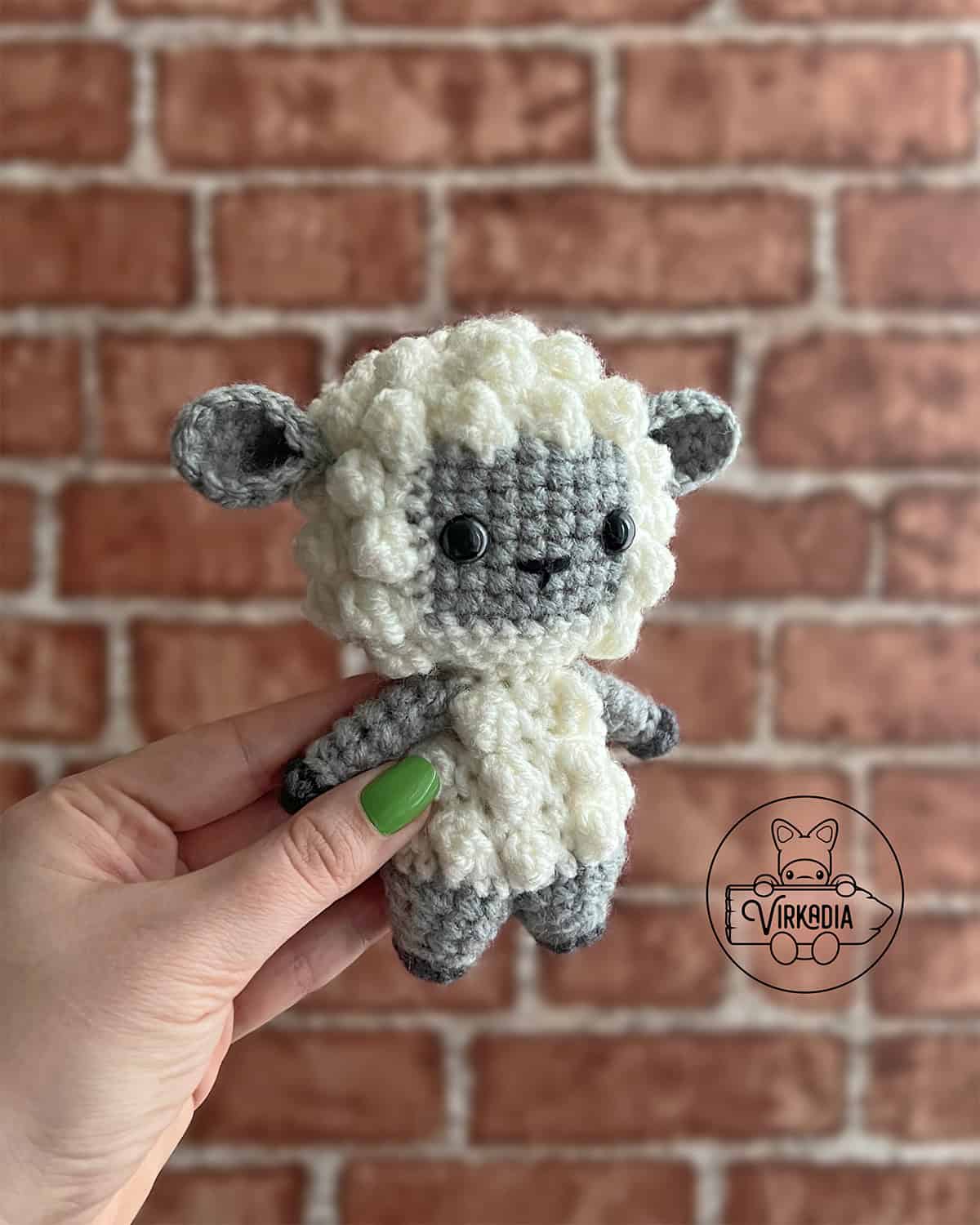 candid shot of free crochet lamb amigurumi plushie for DIY Easter decorations, homemade holiday gifts, animal decor, and spring crafts