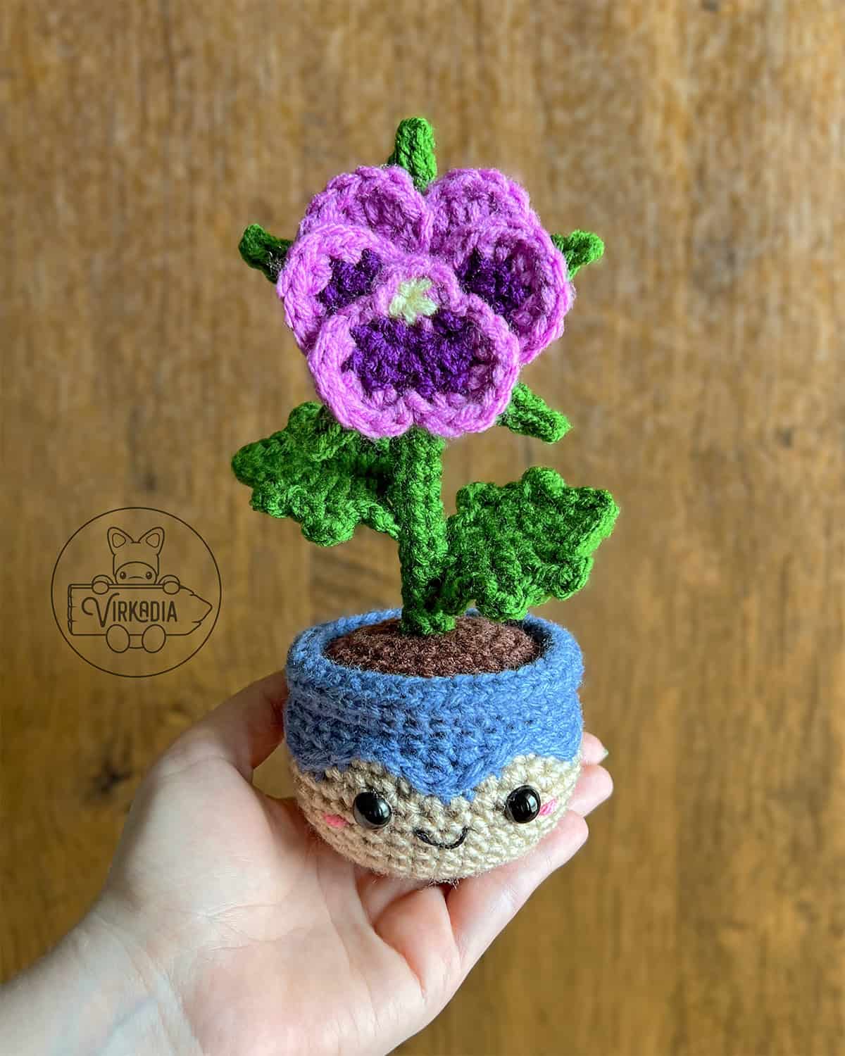 candid shot of free crochet pansy amigurumi plushie for floral decorations, DIY gifts, spring crafts, and plant decor
